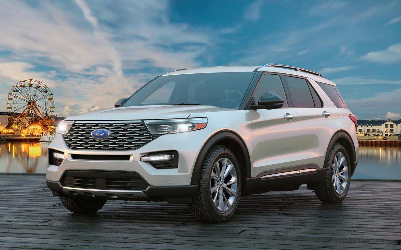 2022 Ford Explorer Platinum parked on a pier with a Ferris wheel in the background