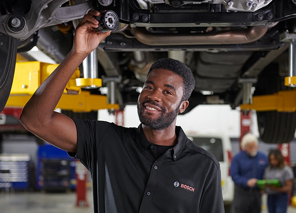 Bosch Auto Service technician working on a vehicle at a service