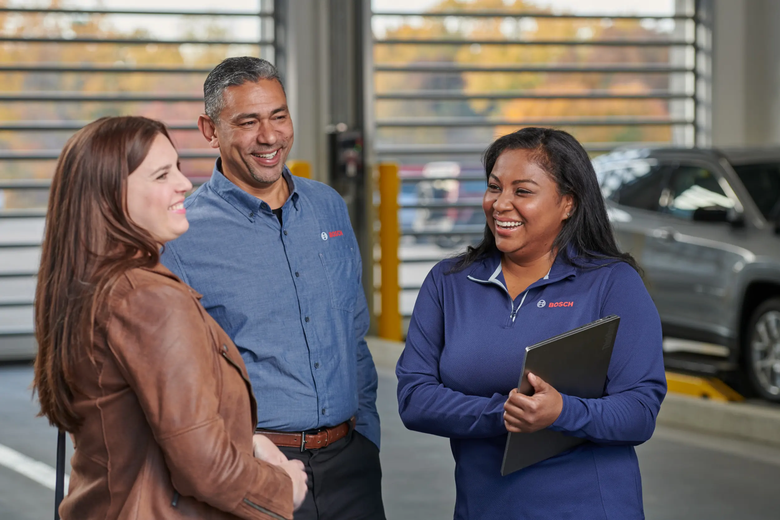 Bosch Auto Service team speaking with a customer after an auto repair appointment
